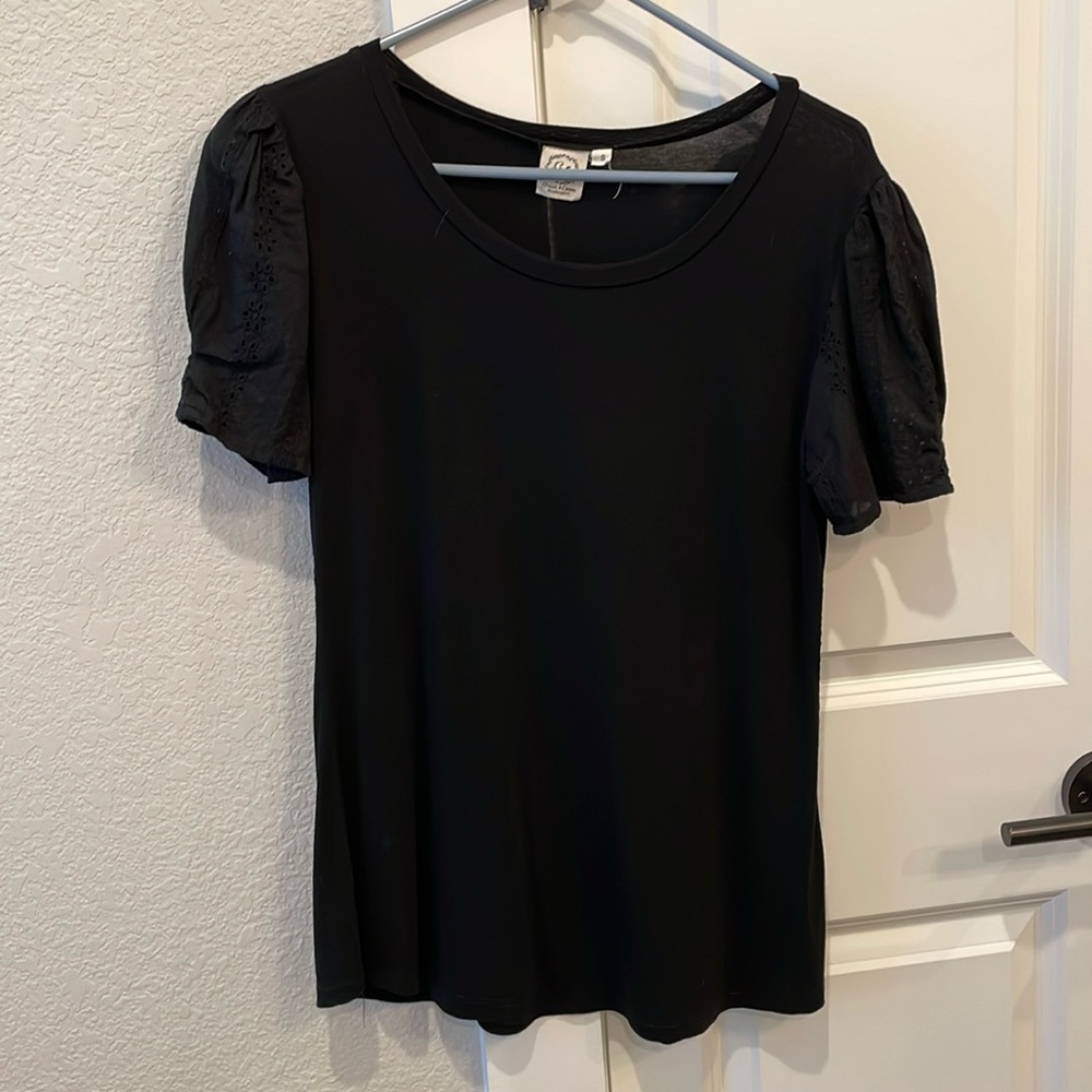 Cute top with eyelet sleeves.